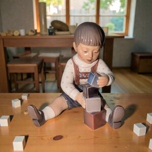 Dahl Jensen porcelain figurine of a boy playing with blocks, model # 1167 Mint!